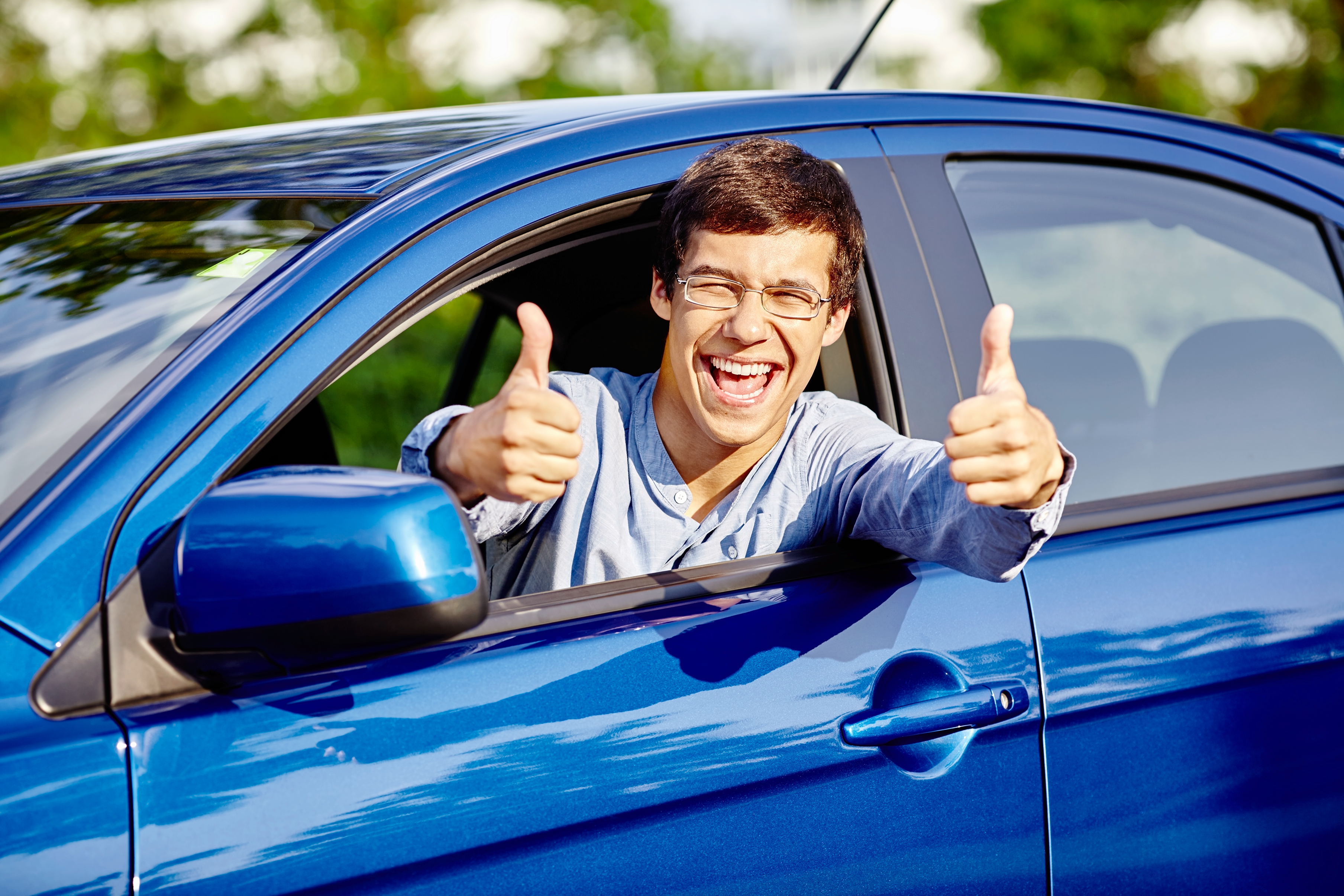 Guy inside car showing thumbs up